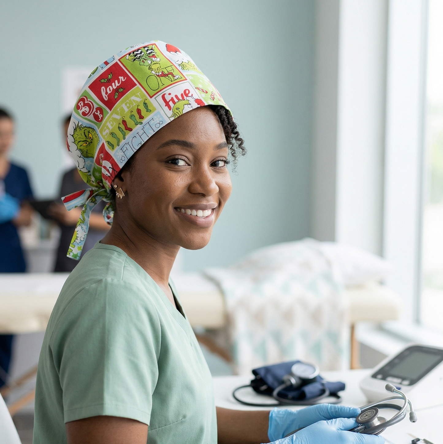 A healthcare professional in a bright clinical hallway wearing the green Grinch cartoon design surgical cap.