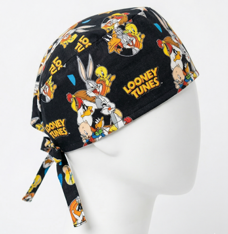 Profile view of the Looney Tunes themed headwear on a white mannequin, highlighting the detailed character print and the secure tie-back closure.