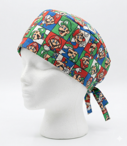 A surgical cap with a vibrant, colorful floral pattern on a dark background, shown in a side profile on a white mannequin head with an adjustable tie-back.