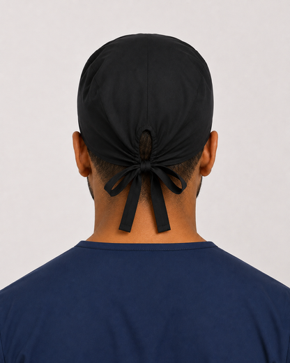 Solid black satin-lined surgical cap, back view showing the tie