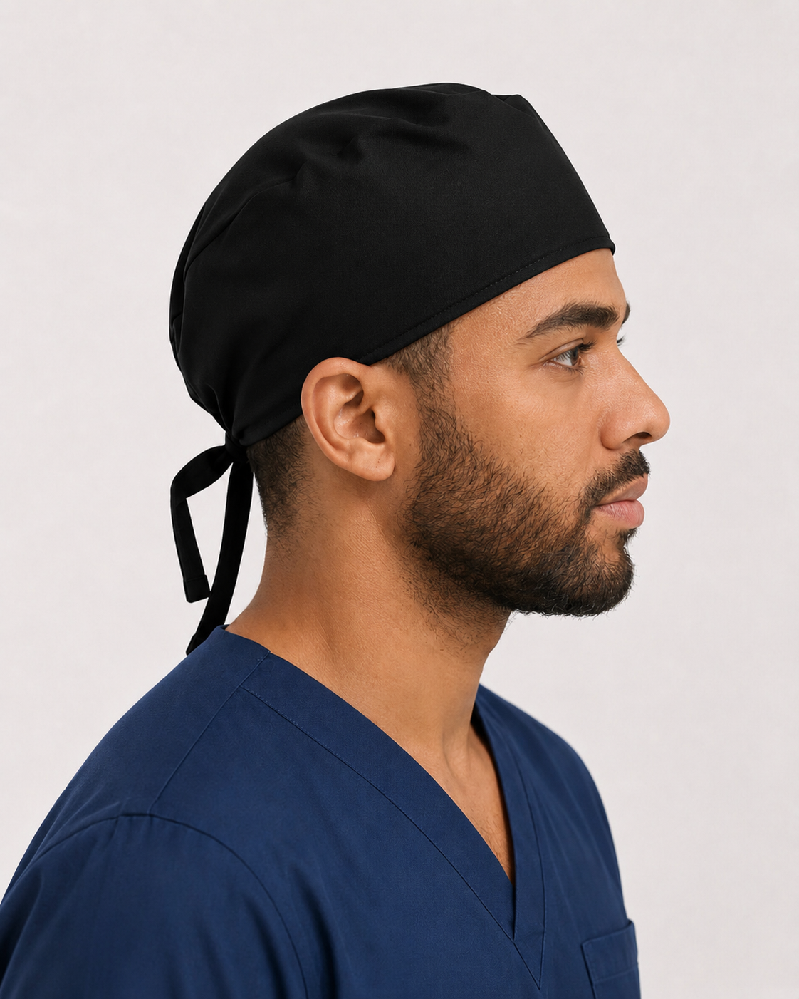 Solid black satin-lined surgical cap, side view