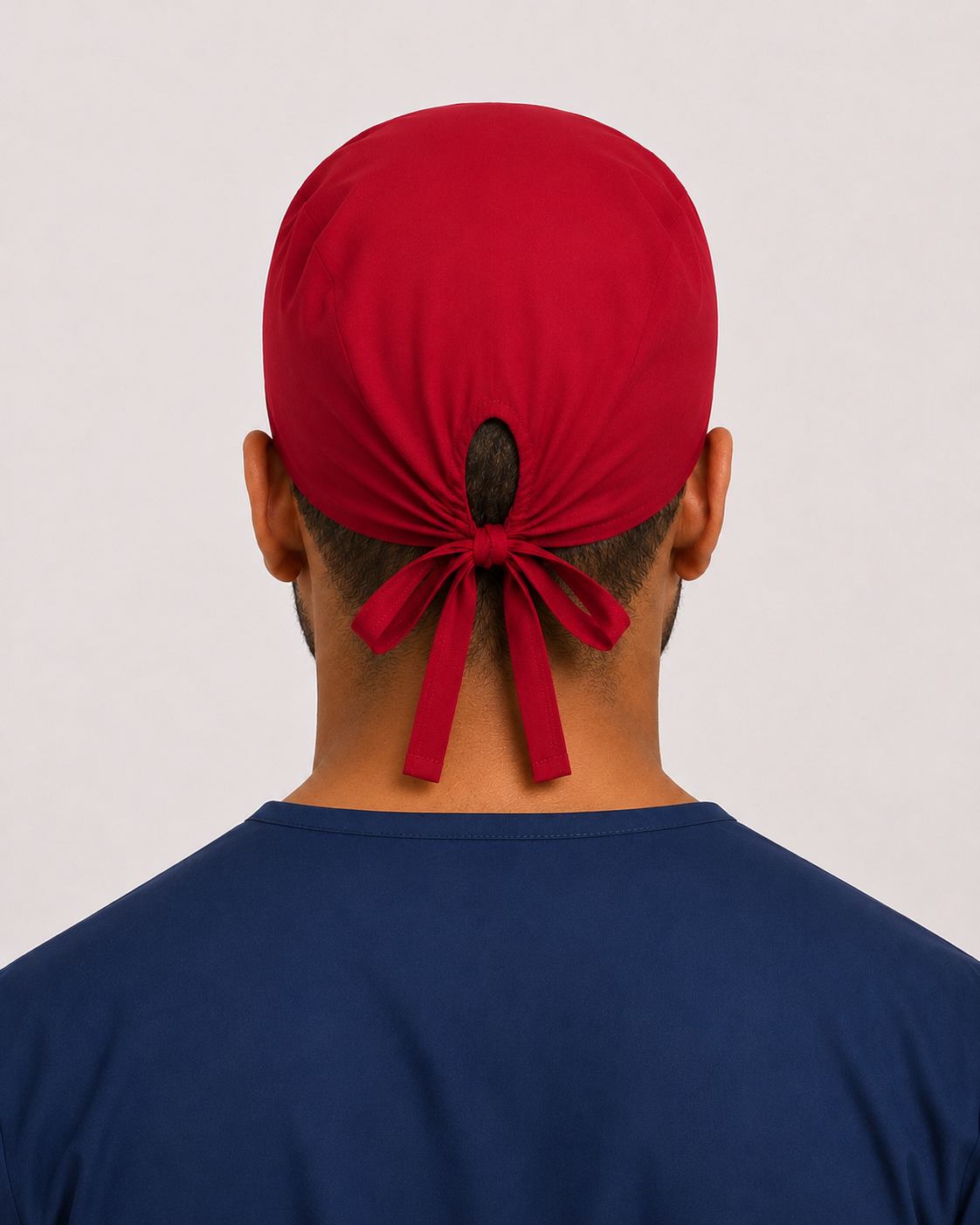 Solid red satin-lined surgical cap, back view showing the tie