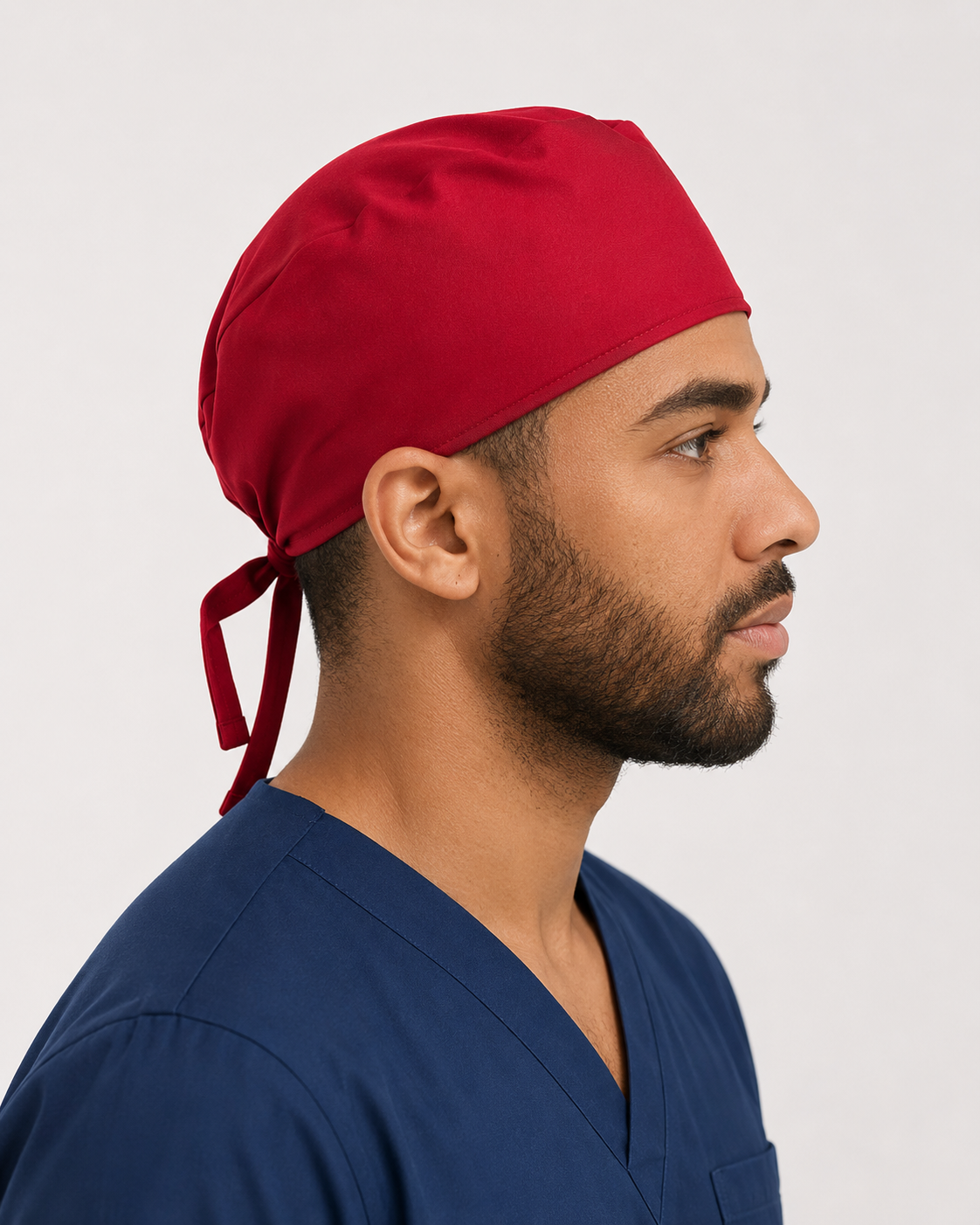 Solid red satin-lined surgical cap worn by a healthcare professional