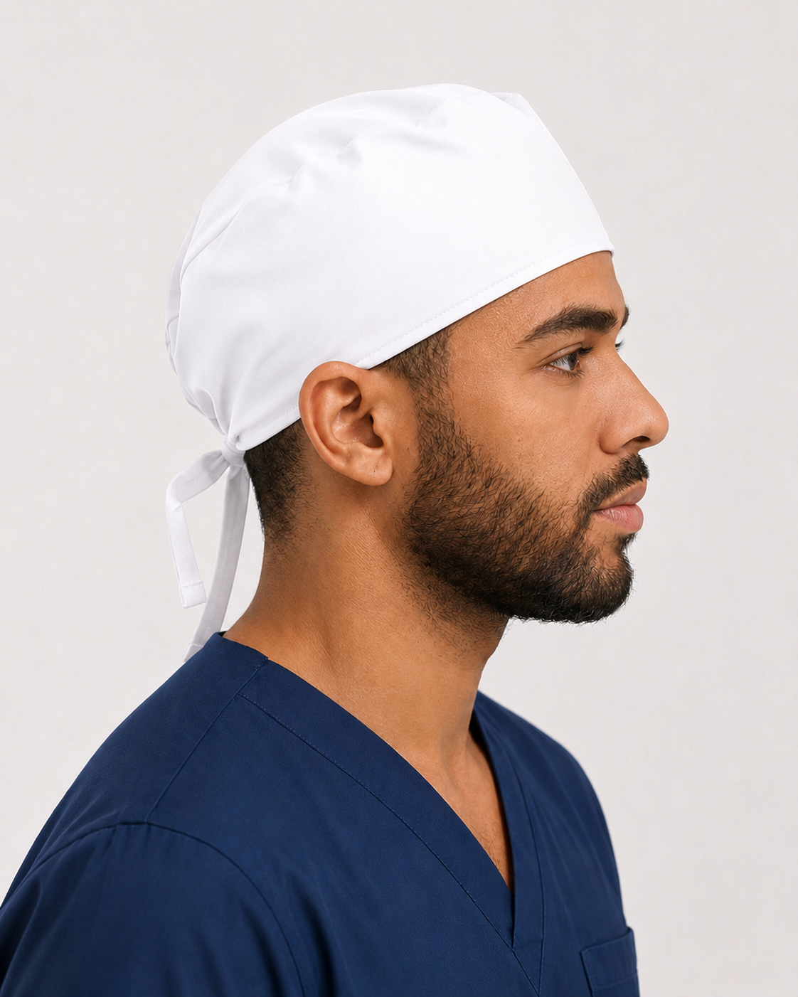 Solid white satin-lined surgical cap, side view